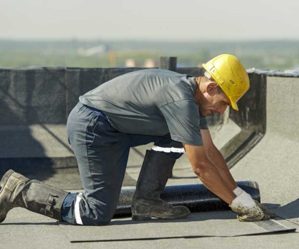 Roof Connect Contractor performing roof repairs on a commercial flat roof in New york